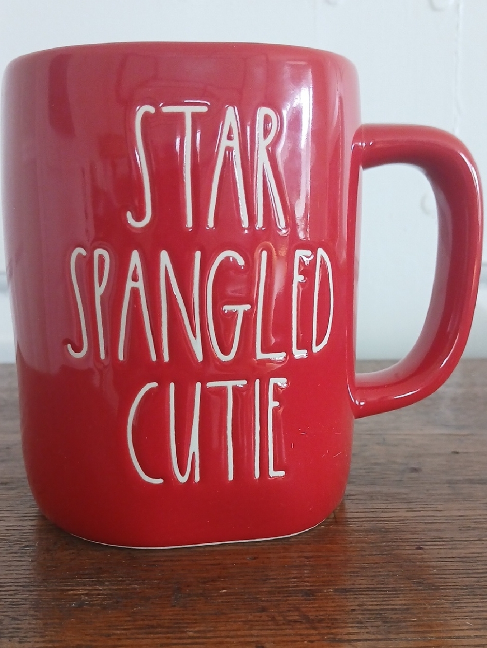 Rae Dunn "Star Spangled Cutie" red ceramic coffee mug.